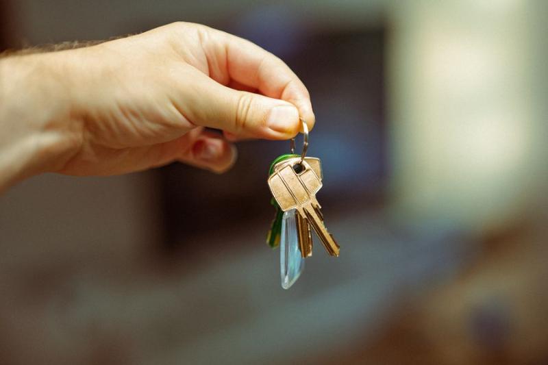 Hand holding keys to a new home