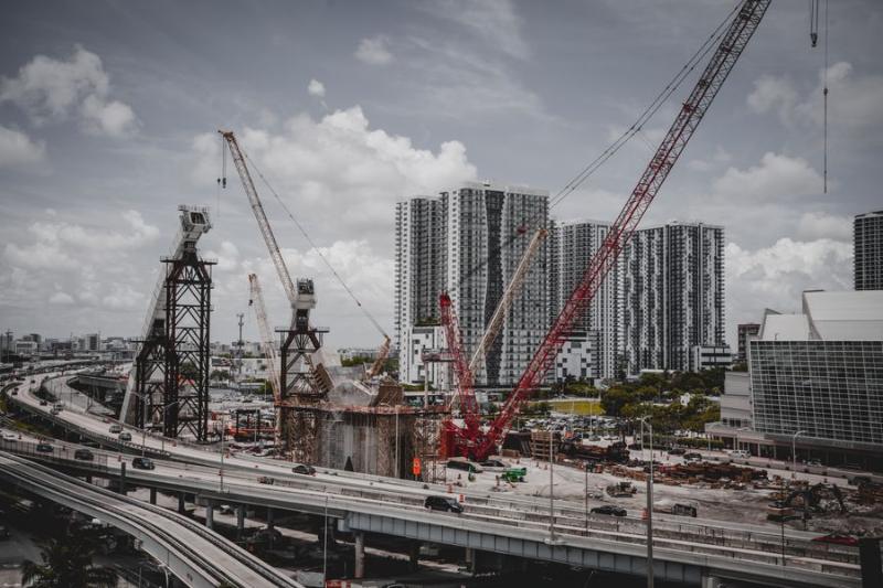 Construction cranes over a new residential development in Singapore
